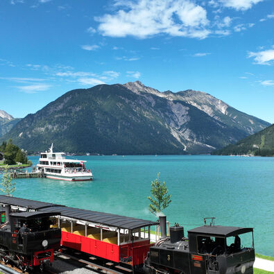 The aerial view shows an Achensee boat and the Achensee railway at the Seespitz landing stage in summer.