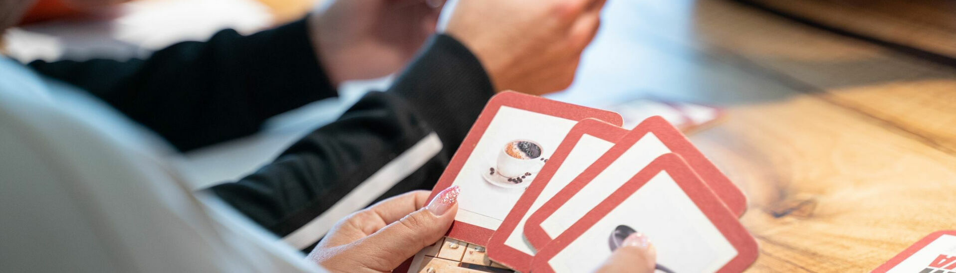 Mit Bildkarten lernt eine Gruppe in einem Deutschkurs.}