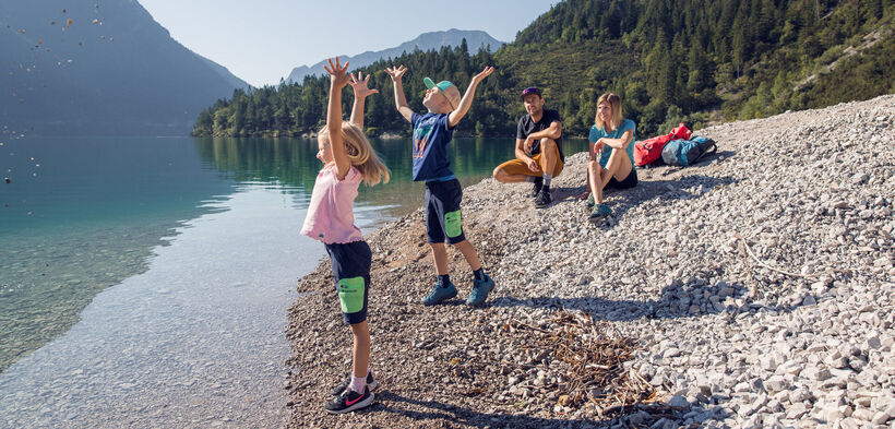 A family exploring the Gaisalmsteig on a sunny day, enjoying the beautiful natural surroundings.
