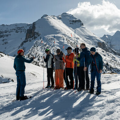 A group of snowshoers attending an avalanche awareness lecture learn how to use a probe.